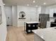 Bright, modern kitchen with stainless steel appliances, quartz countertops, and an island with storage at 1900 Erudite Way, Winter Park, FL 32792