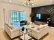 Bright living room with modern decor, sleek lighting, and sliding glass doors leading to outdoor space at 1900 Erudite Way, Winter Park, FL 32792