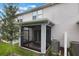 Screened in back patio with seating area and backyard at 1900 Erudite Way, Winter Park, FL 32792
