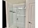 Enclosed shower featuring subway tile, built-in niche, glass door and black metal fixtures at 1900 Erudite Way, Winter Park, FL 32792