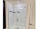 Modern shower featuring white subway tile, a sleek glass door, and modern fixtures at 1900 Erudite Way, Winter Park, FL 32792