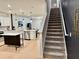 Carpeted staircase with white railings leading to the upper level adjacent to the kitchen at 1900 Erudite Way, Winter Park, FL 32792