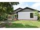The backyard has nice lawn and landscaping with trees surrounding the home at 2524 Shadybranch Dr, Orlando, FL 32822