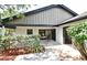 Backyard patio with mature landscaping, covered porch area, and a sliding door to the interior at 2524 Shadybranch Dr, Orlando, FL 32822