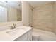 Bathroom with a single sink vanity and tub with light beige tile surround at 2524 Shadybranch Dr, Orlando, FL 32822
