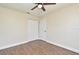 This bedroom features wood look flooring, a ceiling fan, and a closet with bi-fold doors at 2524 Shadybranch Dr, Orlando, FL 32822