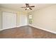 Large bedroom with ceiling fan, wood-look tile floors, and dual closets for ample storage space at 2524 Shadybranch Dr, Orlando, FL 32822
