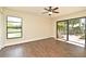 Bedroom features wood-look flooring, a window view of the pond, and sliding glass doors to the backyard patio at 2524 Shadybranch Dr, Orlando, FL 32822