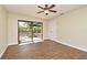 Bedroom featuring wood-look flooring, ceiling fan, and sliding glass doors to the backyard patio at 2524 Shadybranch Dr, Orlando, FL 32822