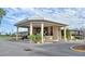 An exterior view of the community clubhouse with well-manicured landscaping at 2524 Shadybranch Dr, Orlando, FL 32822