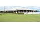 View of the clubhouse exterior overlooking manicured lawn and patio at 2524 Shadybranch Dr, Orlando, FL 32822