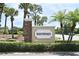 Well manicured community entrance with the Shadybranch sign with palm trees and trimmed green bushes at 2524 Shadybranch Dr, Orlando, FL 32822