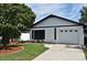 Charming home featuring a one-car garage, well-manicured lawn, and mature landscaping at 2524 Shadybranch Dr, Orlando, FL 32822
