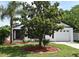 Inviting home featuring a well-maintained lawn, mature trees, and a welcoming facade at 2524 Shadybranch Dr, Orlando, FL 32822