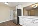 Modern kitchen with stainless steel refrigerator, white cabinetry, and breakfast bar overlooking dining area at 2524 Shadybranch Dr, Orlando, FL 32822