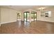 Open-concept living room featuring wood-look tile flooring and sliding glass doors at 2524 Shadybranch Dr, Orlando, FL 32822
