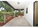This covered patio has access to a garden with mature landscaping at 2524 Shadybranch Dr, Orlando, FL 32822