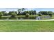 Calm pond view with a walking path and bright green grass in a beautiful community setting at 2524 Shadybranch Dr, Orlando, FL 32822