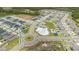 This aerial view showcases a residential area with winding streets, a community pool, and playgrounds at 2716 Pierr St, Davenport, FL 33837
