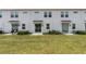 Townhome backyard with green lawn, patio, and barbecue grill, perfect for outdoor entertaining and relaxation at 2716 Pierr St, Davenport, FL 33837