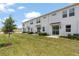 Wide angle shot of backyard featuring a lush lawn and sliding doors, creating seamless indoor-outdoor living at 2716 Pierr St, Davenport, FL 33837