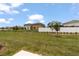Backyard view of several houses with a white fence at 2716 Pierr St, Davenport, FL 33837