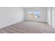 A bright, neutral bedroom with carpet floors and double windows at 2716 Pierr St, Davenport, FL 33837