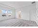 Bright bedroom featuring tray ceilings, carpeted floors, and a view of the backyard at 2716 Pierr St, Davenport, FL 33837