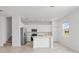 Bright kitchen with white cabinets, stainless steel appliances, tile floors, and a center island at 2716 Pierr St, Davenport, FL 33837
