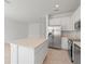 Spacious kitchen with a center island, stainless steel appliances, and lots of counter space at 2716 Pierr St, Davenport, FL 33837