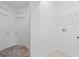 A bright, white laundry room with tile floor and access to the bedroom at 2716 Pierr St, Davenport, FL 33837