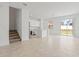 Open-concept layout with a view of the kitchen, staircase, and sliding doors to the backyard at 2716 Pierr St, Davenport, FL 33837