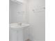 Powder room featuring a pedestal sink, mirror, and chrome towel rack at 2716 Pierr St, Davenport, FL 33837