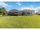 Expansive backyard featuring a screened-in pool area, offering great outdoor living and entertaining space at 2746 Windsorgate Ln, Orlando, FL 32828