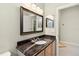 Bathroom with granite-topped vanity and large mirror at 2746 Windsorgate Ln, Orlando, FL 32828