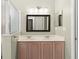 Bright bathroom featuring double sinks and a dark-framed mirror at 2746 Windsorgate Ln, Orlando, FL 32828