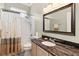Bathroom with shower-tub combo and granite-topped vanity at 2746 Windsorgate Ln, Orlando, FL 32828