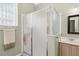 Bright bathroom featuring a frosted shower and a mirror above a single sink at 2746 Windsorgate Ln, Orlando, FL 32828