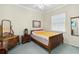 Comfortable bedroom with a ceiling fan, natural light, and vintage furniture at 2746 Windsorgate Ln, Orlando, FL 32828