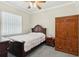 Traditional bedroom with ceiling fan, an armoire, and a window that offers natural light at 2746 Windsorgate Ln, Orlando, FL 32828