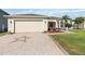 Paved driveway leading to a two-car garage, enhanced with a decorative star pattern at 2746 Windsorgate Ln, Orlando, FL 32828