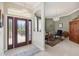 Home foyer featuring tile flooring, chandelier, and decorative glass front door at 2746 Windsorgate Ln, Orlando, FL 32828