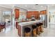 Well-lit kitchen boasts stainless steel appliances, granite countertops, and a breakfast bar with seating at 2746 Windsorgate Ln, Orlando, FL 32828