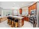 Modern kitchen features granite countertops, stainless steel appliances, and seating area for entertaining at 2746 Windsorgate Ln, Orlando, FL 32828