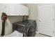 Convenient laundry room with large washer, dryer, shelving and ample space for laundry tasks at 2746 Windsorgate Ln, Orlando, FL 32828