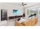 Comfortable living room featuring a large sectional sofa, a modern entertainment center, and lots of light at 2746 Windsorgate Ln, Orlando, FL 32828