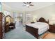 Spacious main bedroom with ceiling fan, vanity, and sliding glass door to outdoor living area at 2746 Windsorgate Ln, Orlando, FL 32828
