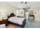 Well-lit main bedroom features a ceiling fan and elevated ledge for decor and photos at 2746 Windsorgate Ln, Orlando, FL 32828