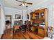 Inviting office features wood floors, built-in shelving, and a large desk perfect for working from home at 2746 Windsorgate Ln, Orlando, FL 32828