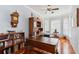 Home office featuring hardwood floors, a large desk, and a built-in bookcase at 2746 Windsorgate Ln, Orlando, FL 32828